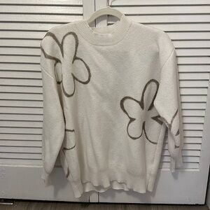 White sweater with flower pattern
